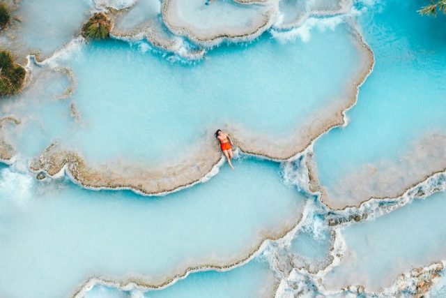 man sitting in body of water