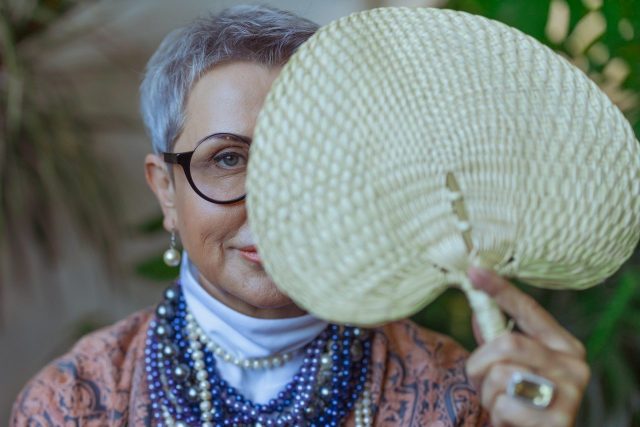 Photo Of Woman Holding A Fan