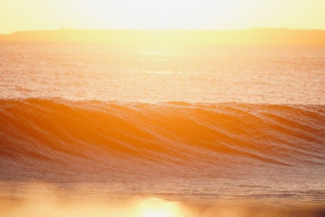 a person riding a wave on top of a surfboard